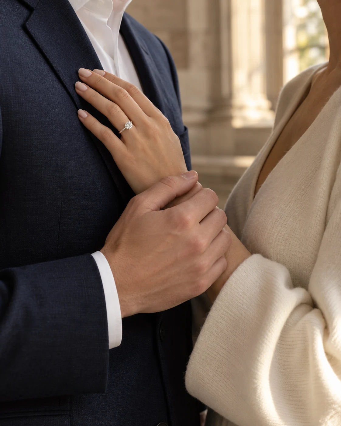 AI illustration: an engaged couple cropped below the face, with a round solitaire on her hand; not the original customer or ring