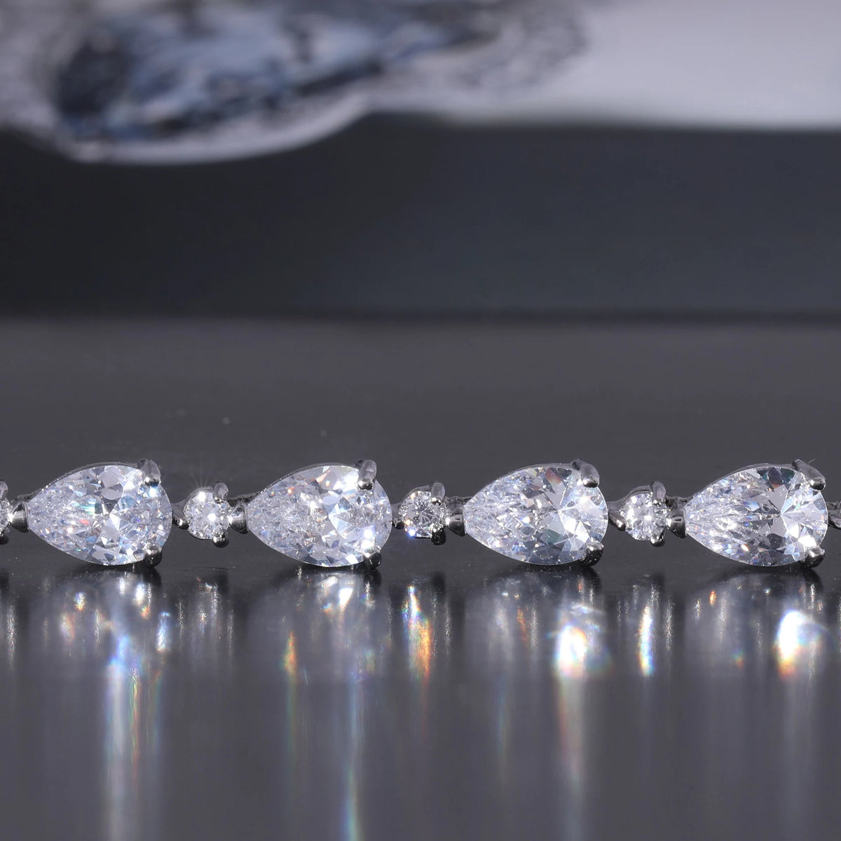 Stock macro of pear-cut stones reflecting on a dark surface